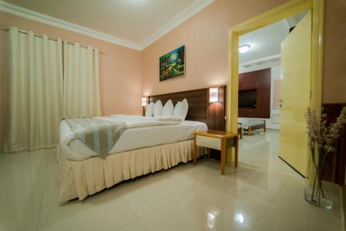 a hotel room with a bed and a television at Al Ghubrah Plaza Hotel in Muscat