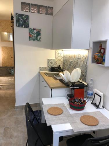 a small kitchen with a table and a counter top at Via Idria 14 in Catania