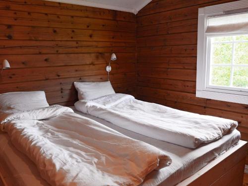 A bed or beds in a room at Holiday home Utvik III