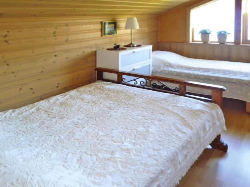 Tempat tidur dalam kamar di Holiday home TYSSE