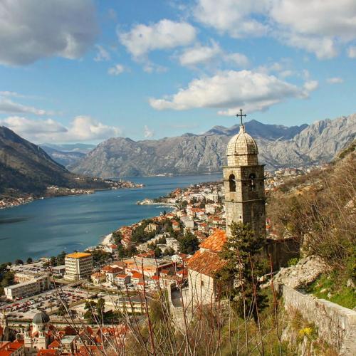 a view of a city with a church and a river at Old town Kotor Square in Kotor