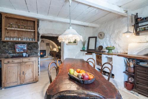 a kitchen with a wooden table with a bowl of fruit on it at Rustic Art House Kras Krk in Kras