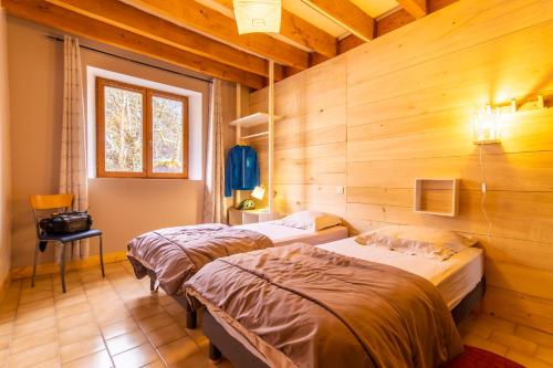Ліжко або ліжка в номері Les MARMOTTES pour 12 avec bain nordique privatif