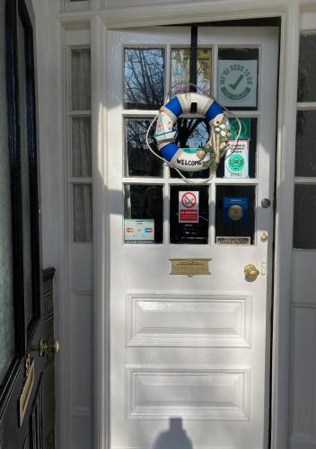 a white door with a bunch of stickers on it at Shearwater in Bridlington