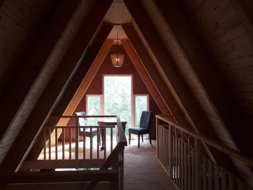 a room with a table and chairs in a attic at A-frame volledig vrijstaande woning in Hensbroek