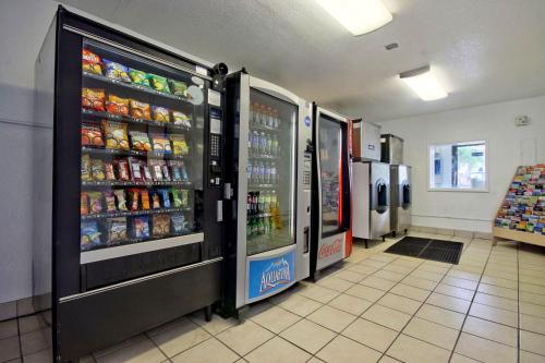 a grocery store aisle with two refrigerators and drinks at Motel 6 Dania Beach in Dania Beach