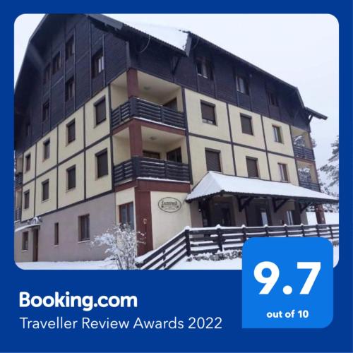 a picture of a building with snow on it at Apartman Jelen in Kaludjerske Bare