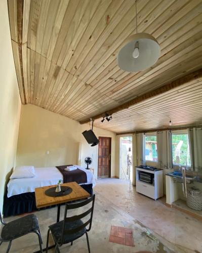 a bedroom with a bed and a wooden ceiling at Casa Estúdio com cozinha completa - Centro Serra do Cipó in Serra do Cipo