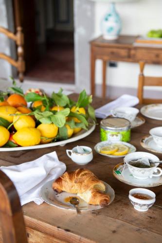 a table with two plates of food and a plate of fruit at Il Castello di San Michele in San Michele in Teverina