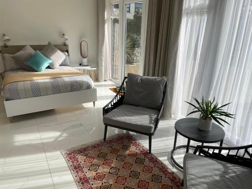 a living room with a bed and a chair at Garden Room in Kirton in Lindsey