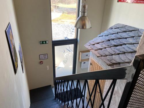 a stairway with a view of a room with a window at Le Héron - Gîte de charme clôturé, accès à la rivière - 6 ou 10 personnes in Fauvillers