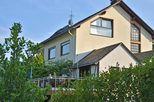 a large house with trees in front of it at Weingut Rosenbaum in Briedel