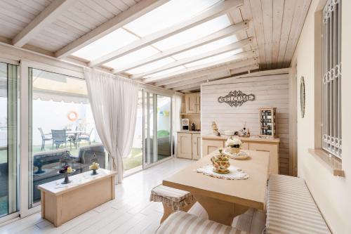 una cucina con tavolo e una grande finestra di Elegante Villetta a Viareggio
