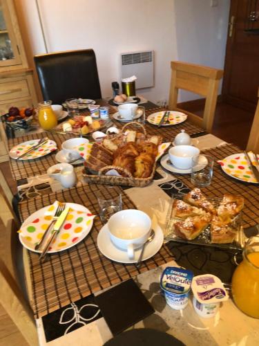 a table with food and dishes on top of it at La Grange bnb in Yviers
