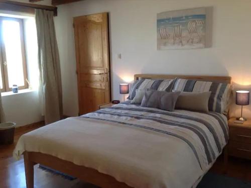 a bedroom with a large bed and a window at La Grange bnb in Yviers