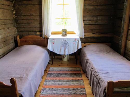 A bed or beds in a room at Yläpihan Tila