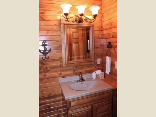 a bathroom with a sink and a mirror at Trickling Waters Retreat in Marquette