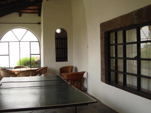 a room with a table and chairs and a window at Rancho Hotel Atascadero in San Miguel de Allende