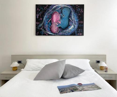 a bedroom with a bed with a painting on the wall at Il vecchio Fauno in Pompei