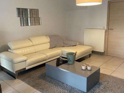 a living room with a couch and a coffee table at Modern Spanish Hacienda - 10km from the coast in Ichtegem