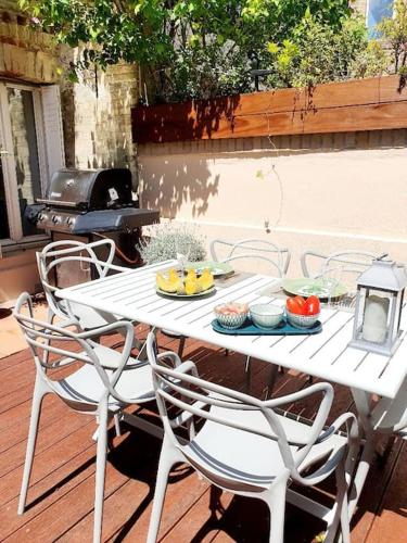 a white table and chairs with food on it at Villa Bon Accueil in Deauville