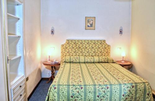 Posteľ alebo postele v izbe v ubytovaní Hotel Torcolo "Residenze del Cuore"