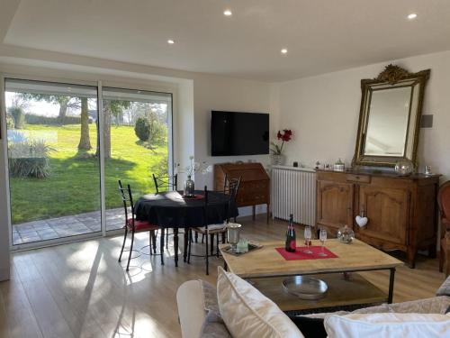 a living room with a table and a dining room at Gite du SERAYOL in Morlhon-le-Haut