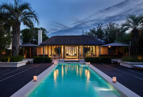 a house with a swimming pool in front of a house at Posada Tamarindo in José Ignacio