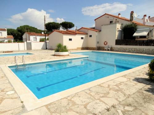 a swimming pool in front of a house at Can Eugeni in L'Escala