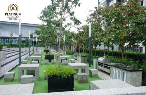 a park with concrete benches and trees and a building at The Lake-ville KL Jalan Kuching by M Platinum in Kuala Lumpur