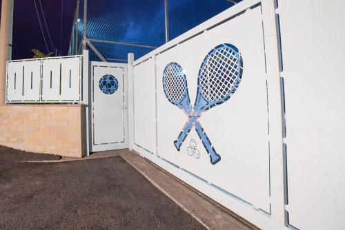 two doors with tennis rackets painted on them at Fronte Etna in Bronte