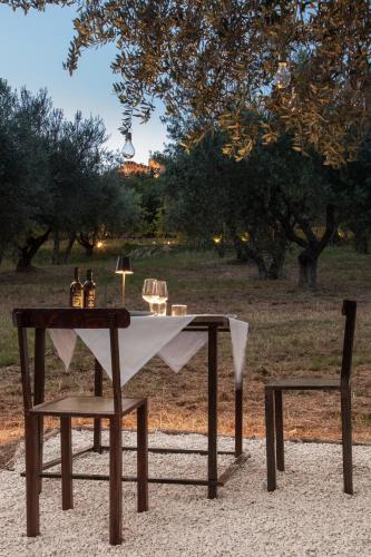 a table and a chair with a white table cloth on it at Terra di Gradara in Gradara