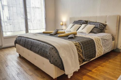 a bedroom with a large bed with blankets and pillows at ❂ Les Logis de la Trémoille ❂ Cozy ❂ Netflix ❂ in Thouars