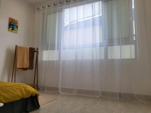 a bedroom with a window with a white curtain at BA CON ECH Home and Stay- No 28 lane 259 Nguyen Duc Canh in Hai Phong