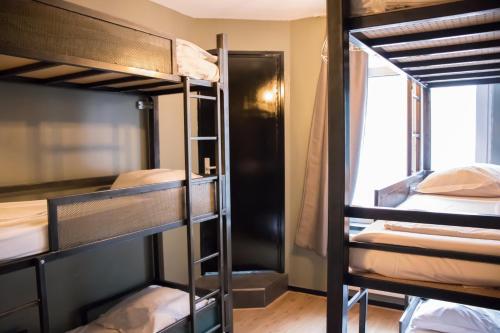 a group of bunk beds in a dorm room at Amsterdam Hostel Sarphati in Amsterdam