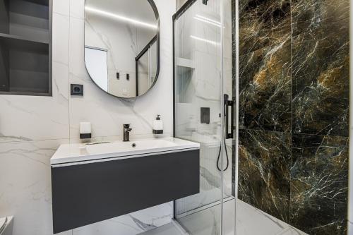 a bathroom with a sink and a mirror at Luxury Waterfront 3-bedrooms Apartment in Odesa