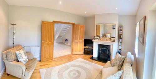 a living room with a couch and a fireplace at Waterville Beenbane Lodge Kerry in Waterville