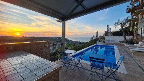 a house with a swimming pool with a sunset at Il Nido B&B in San Vito Chietino