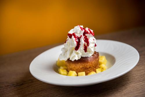 a white plate with a dessert on a table at Logis Le Relais de Sassenage in Sassenage