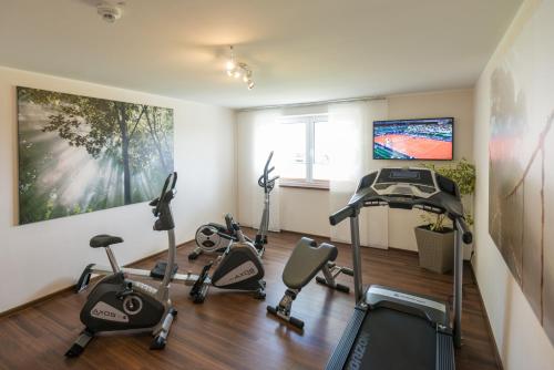 a gym with several exercise bikes in a room at Brauers Landarthotel GmbH in Daun
