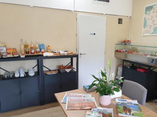 a room with a table and shelves with food at Chambres et Table d'hôtes "La Pastorale Gourmande" FR - NE - EN - DE - IT in Marcollin