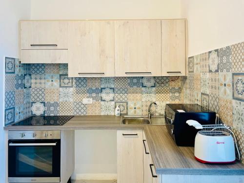 a kitchen with wooden cabinets and a sink at L'Orto di Grace in Sorrento