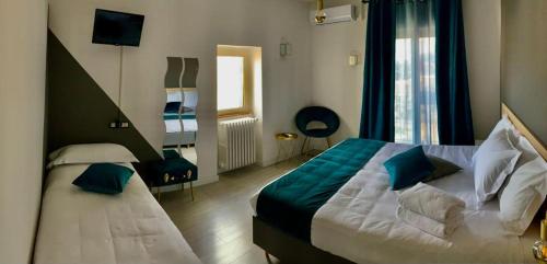 a hotel room with a bed and a window at Slow Living B&B in Matera