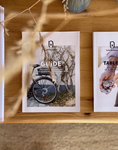 a shelf with two pictures of a bike on it at Le Parc des Mimosas in Noirmoutier-en-l'lle