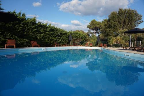 a large swimming pool with blue water at Le Parc des Mimosas in Noirmoutier-en-l'lle