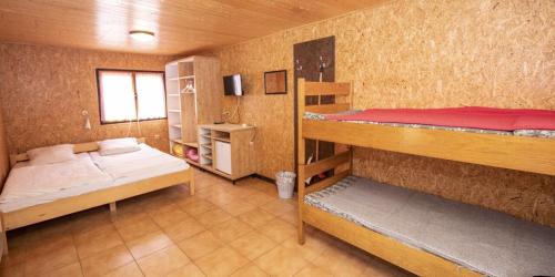 a small room with two bunk beds in it at Chatový areál Zděřina in Police nad Metují