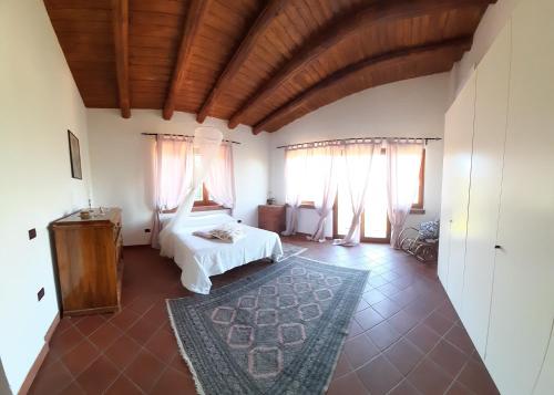 a bedroom with a bed and some windows at Casa Paloma Private Villa in Cicerale
