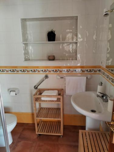 a bathroom with a sink and a toilet at Casa das Mareas in Muros