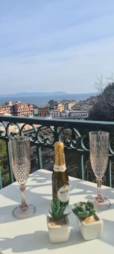 a bottle of champagne on a table with two glasses at I Love Mergellina in Naples