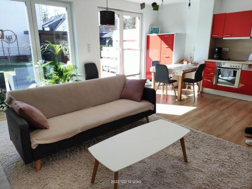 a living room with a couch and a kitchen at Tolle Wohnung in Fontanestadt Neuruppin in Neuruppin